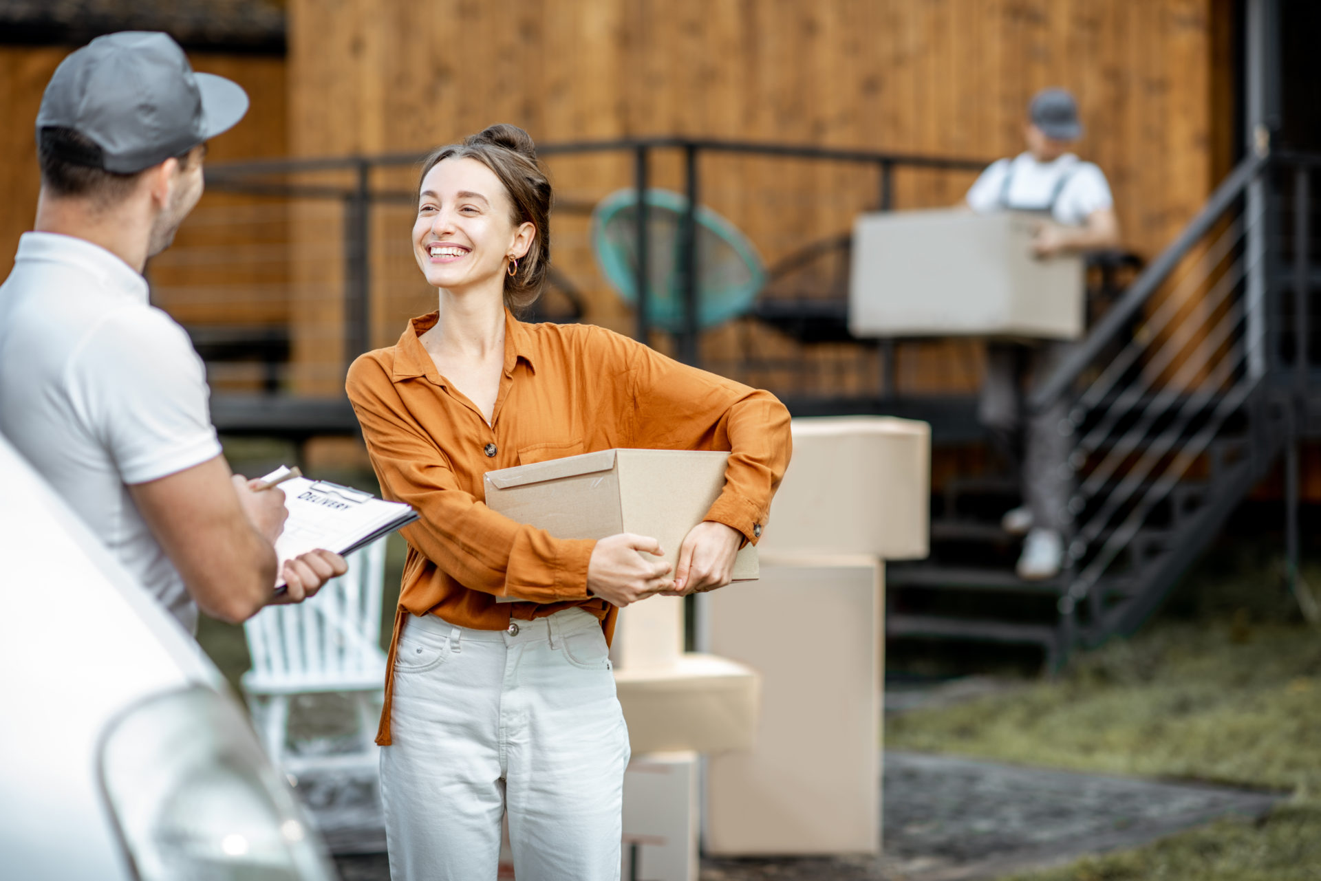 couriers-delivering-goods-to-a-woman-home-1-e1694426501846.jpg